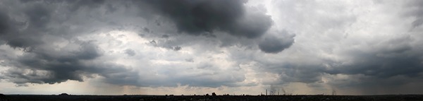 Dark rain clouds over the city, panorama - Miller on the Money