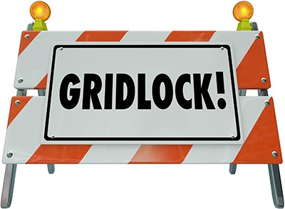 Gridlock sign as a road construction barricade or barrier to illustrate a stoppage, obstruction, challenge, dead end or warning that movement has stopped