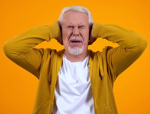 Retired male covering ears by palms displeased with gossips on orange background - Five Words I Never Want To Hear - Miller on the Money